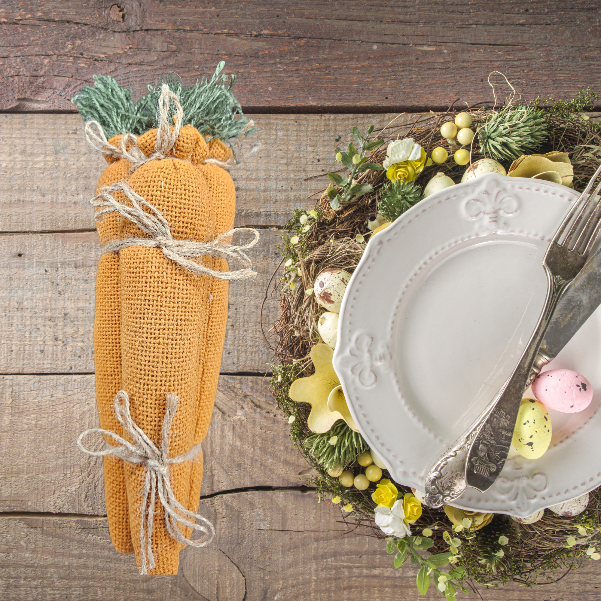 Decorative Easter setting with a carrot Easter wreath on a wooden surface.