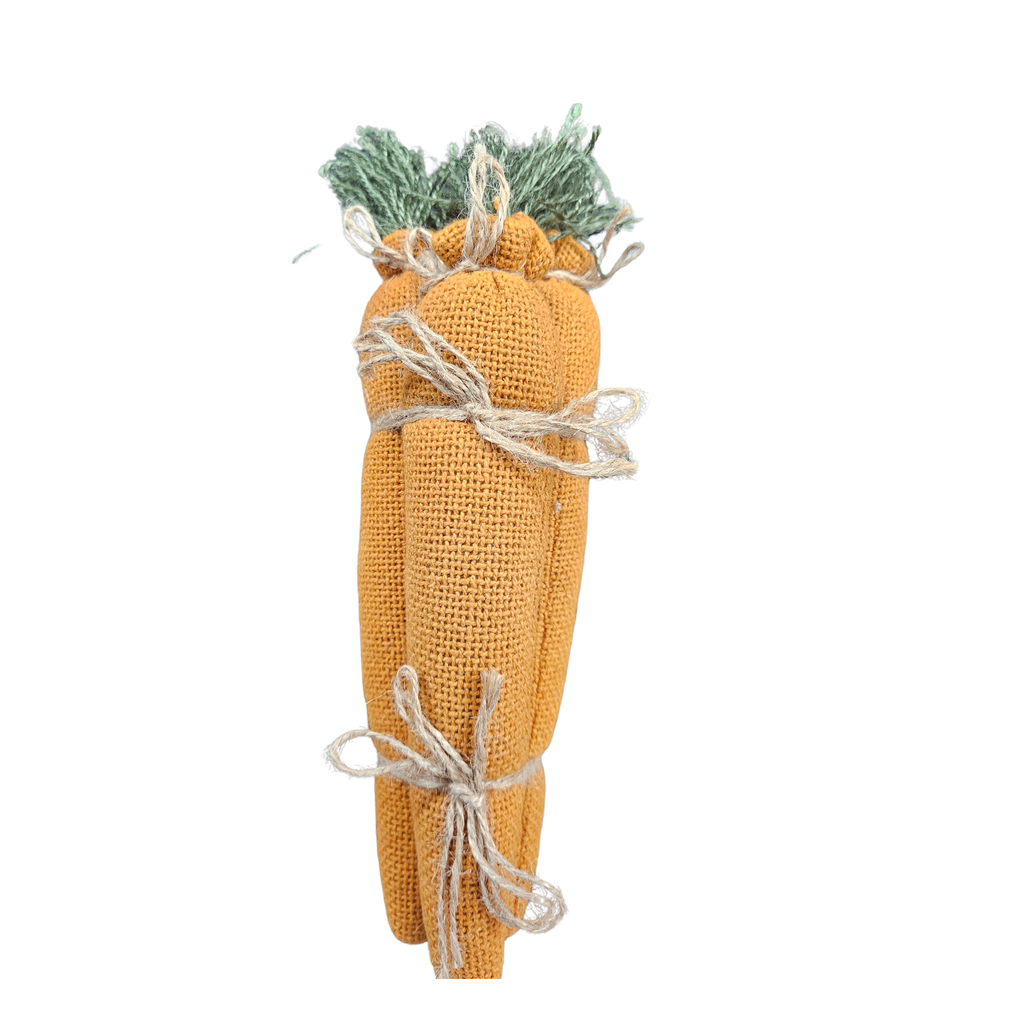 Decorative carrot made of fabric with twine on a white background