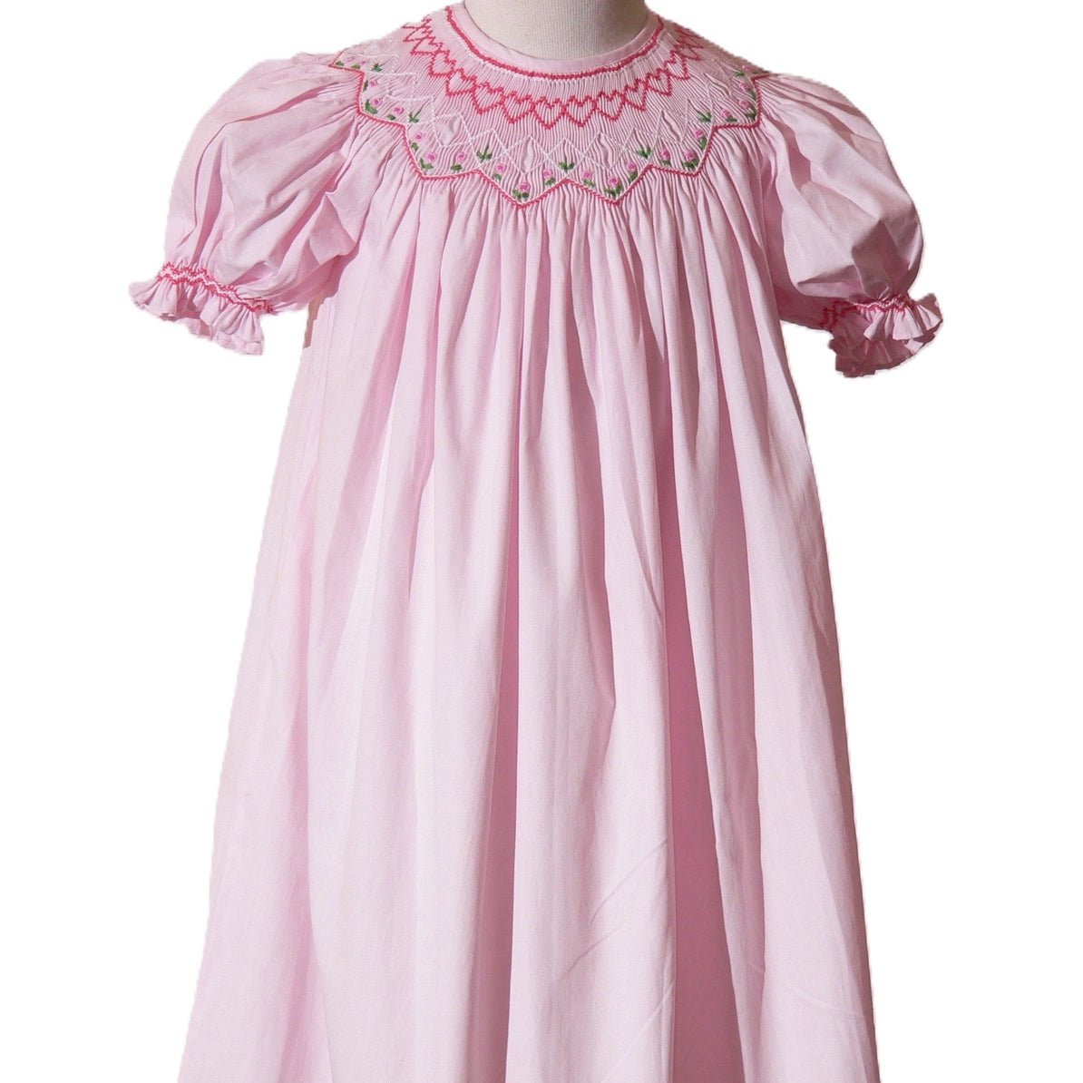 Pink dress with embroidered neckline on a white background