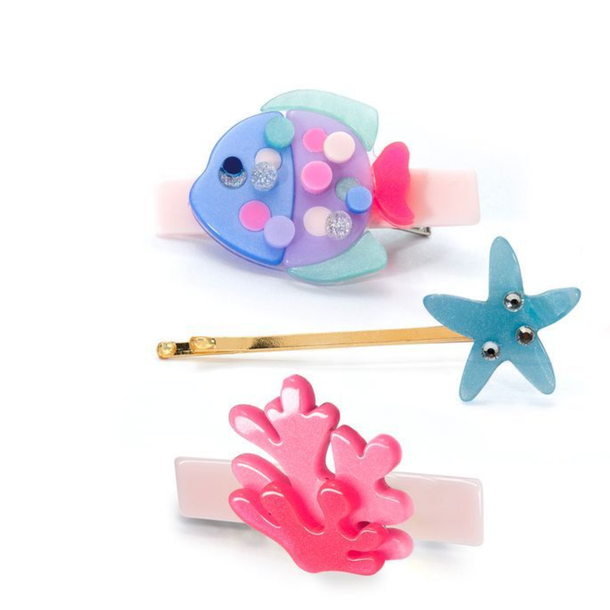 Set of colorful hair accessories including a fish-shaped clip, coral clip, and starfish clip on a white background.