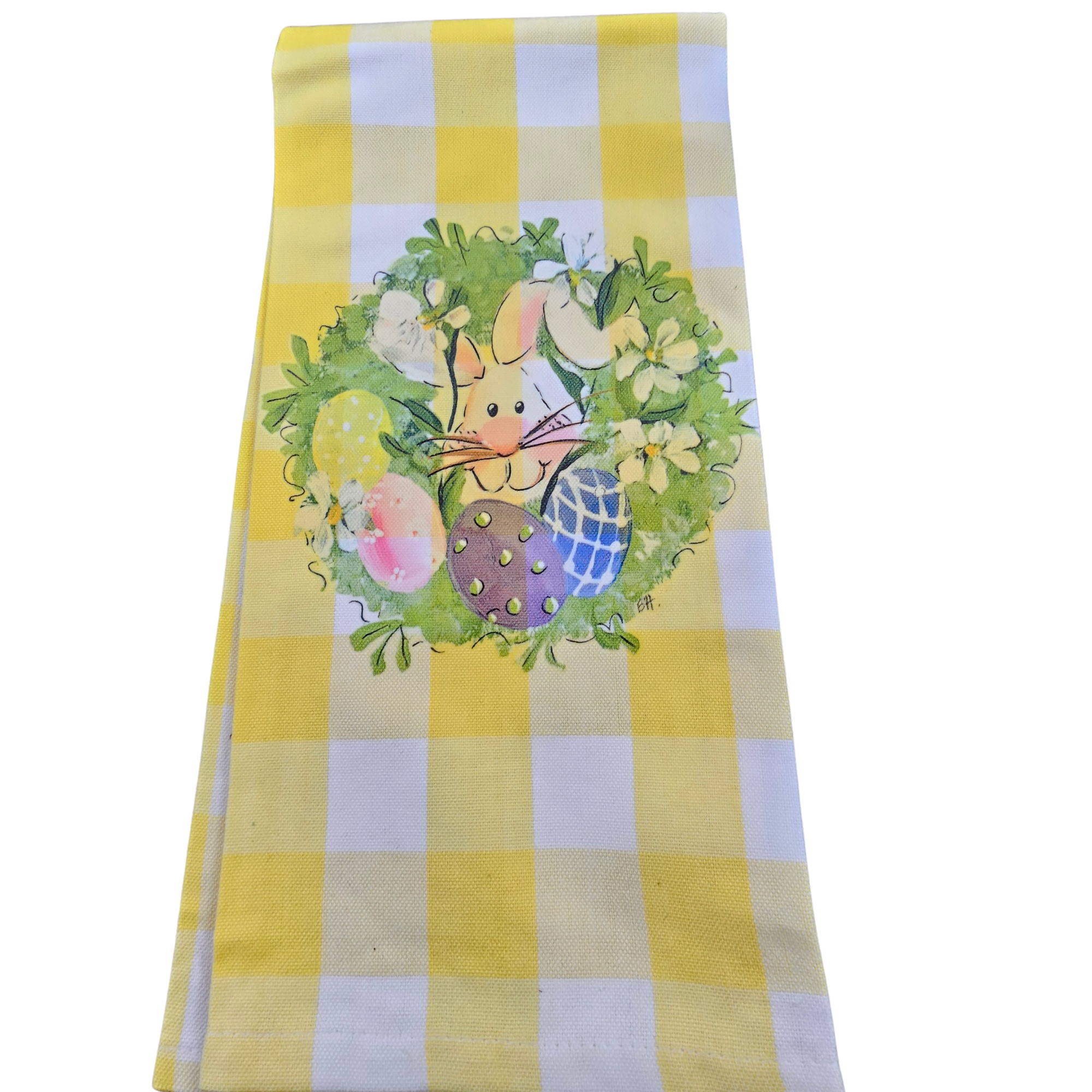 Easter-themed towel with bunny and eggs on a yellow and white checkered background